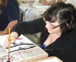 Photo of Chelsea Thomas doing calligraphy